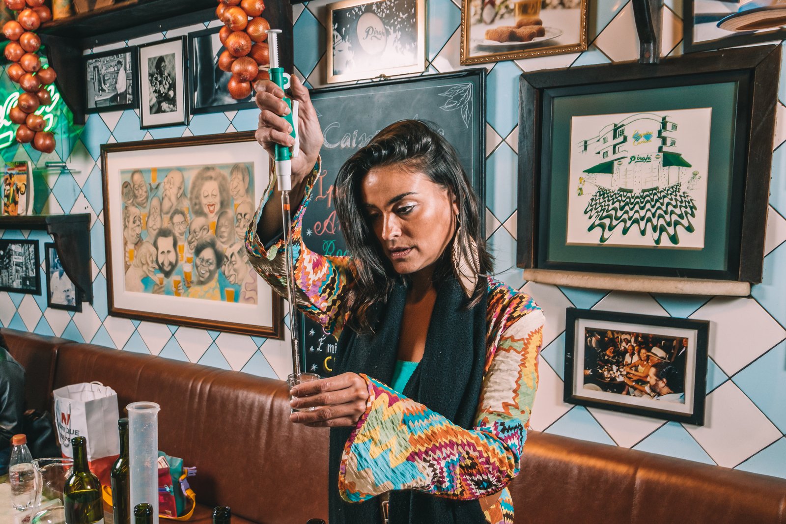 Isadinha in a sensory consulting session, holding a spirits tasting glass
